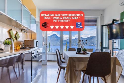 a kitchen with a table and chairs and a sign at Panoramic Lake View Apartments with Pool & Breakfast in Torri del Benaco