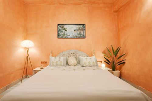 a bedroom with a large white bed with orange walls at Misty BNB And Homestay in Jaipur