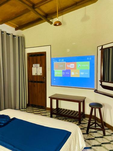a room with a bed and a projection screen at Royal Mount Ella in Ella