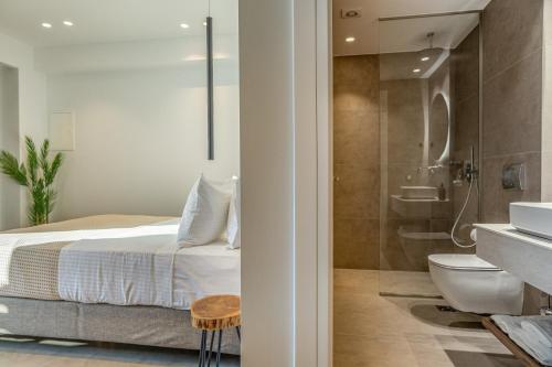 ein Badezimmer mit Bett, Dusche und Toilette in der Unterkunft Sunstar Suites in Syvota