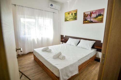 a bedroom with a bed with two towels on it at Villa Mladost Luxury in Veles