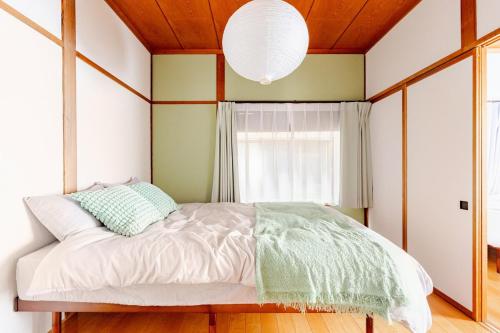 a bedroom with a bed with a large window at AO Niigata in Niigata