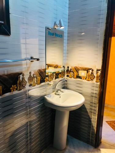 a bathroom with a white sink and a mirror at Reef Beach Camp in Nuweiba