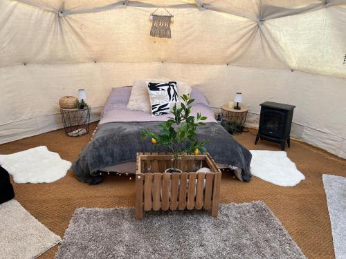 a bedroom with a bed in a tent at Pewsey Countryside Dome - Dog Friendly - Fire pit in Pewsey
