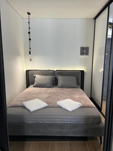 a bed in a room with two towels on it at Manhattan Comfort in Ivano-Frankivsk
