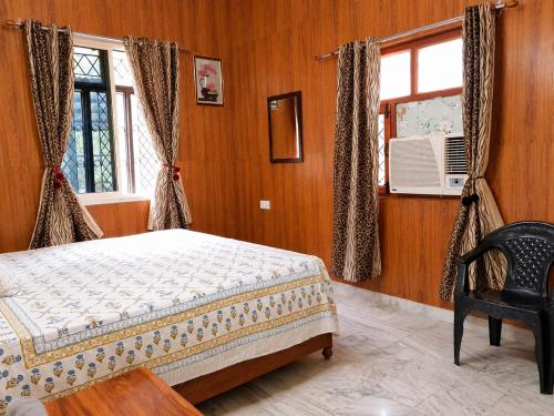 a bedroom with a bed and a window at Ranibagh Riverview Retreat in Kāthgodām