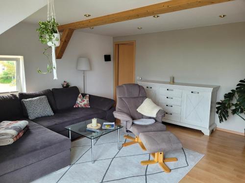 a living room with a couch and two chairs at Bella Vista in Burgstaedt