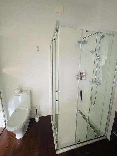 a bathroom with a toilet and a glass shower at M-Room in Málaga