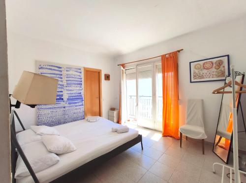 a bedroom with a bed and a window at Maribeach3 Sitges in Sitges