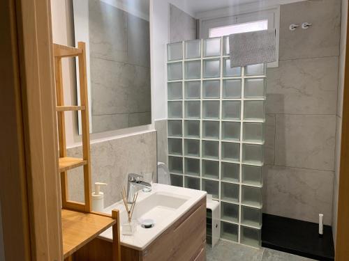 a bathroom with a sink and a shower at Maribeach3 Sitges in Sitges