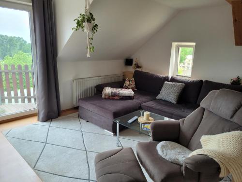 a living room with a couch and a table at Bella Vista in Burgstaedt