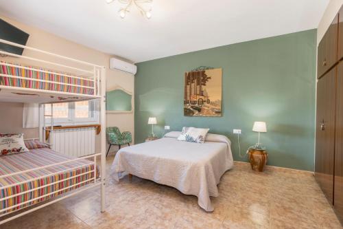 a bedroom with a bed and a bunk bed at Casa Rural Cal Pallol in Camarasa
