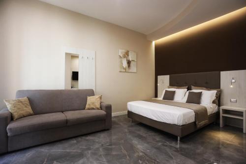 a bedroom with a bed and a couch at DEDA & FOVE in Naples