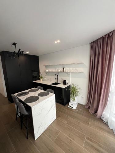 a kitchen with a sink and a counter top at Manhattan Comfort in Ivano-Frankivsk