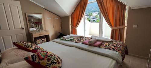 a bedroom with a bed with a large window at Hanem in Cedit