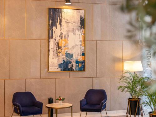 two blue chairs and a table in a lobby at Fairmont Dubai in Dubai