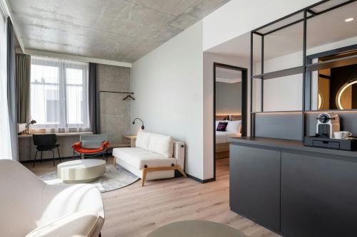 a living room with a bed and a couch at Moxy Budapest Downtown in Budapest