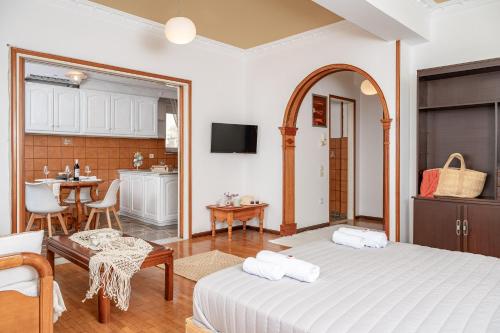 a living room with a bed and a kitchen at SeaView City in Samos
