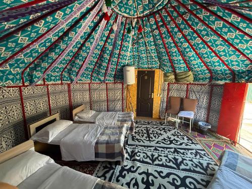 a bedroom with two beds in a yurt at Kausar in Kalīnīno