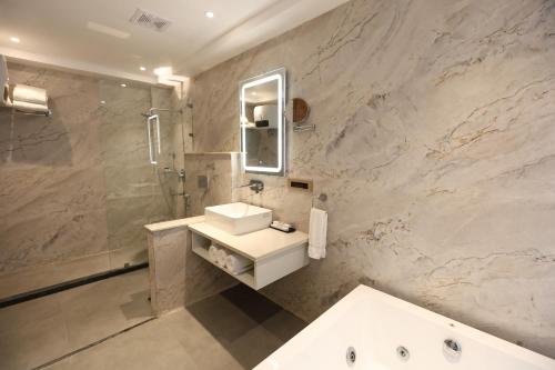 a bathroom with a sink and a shower and a mirror at Ventus Pines in Kasauli