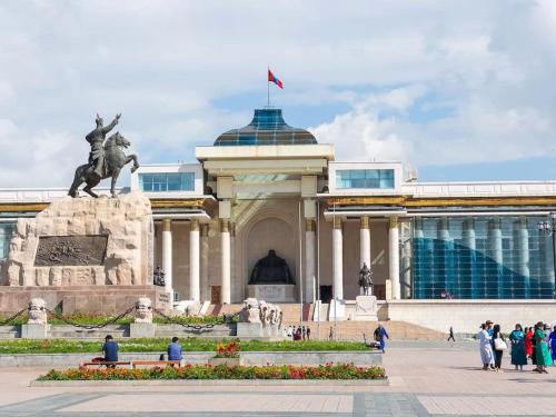 a building with a statue in front of it at Ulaanbaatar Heritage Stay in Ulaanbaatar