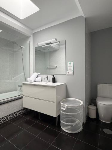 a bathroom with a sink and a toilet and a mirror at Oasis de César- Arquitectura Manriqueña in Costa Teguise