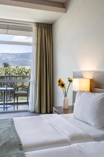 a hotel room with a bed and a balcony at Amalia Hotel Athens in Athens