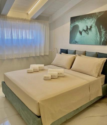 a bedroom with a large bed with towels on it at Domoo Boutique Hotel in Torraca