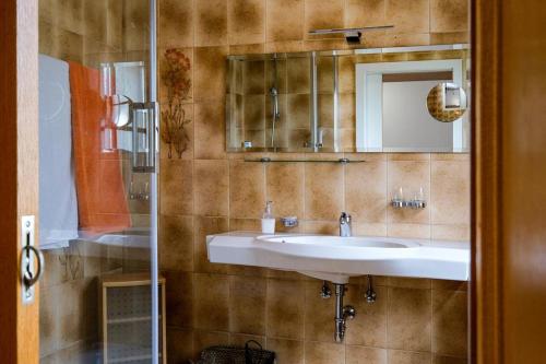 a bathroom with a sink and a mirror at NEU! FeWo Moritz OG in Selters