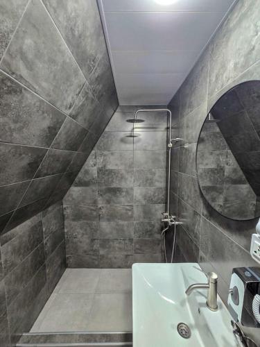 a bathroom with a sink and a shower at Baza Kazbegi in Kazbegi