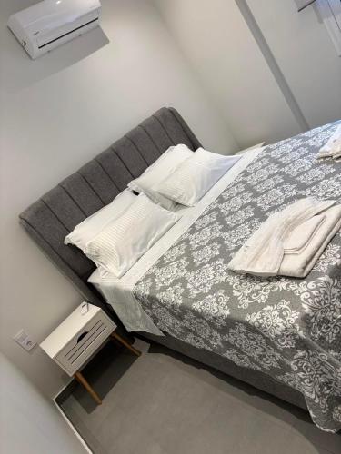 a bedroom with a large bed and a night stand at Fabio apartment in Amarynthos