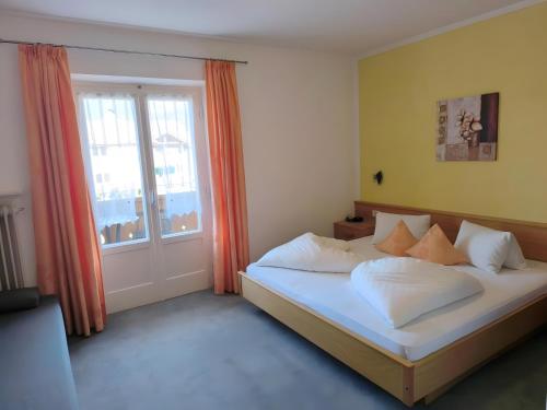 a bedroom with a bed and a large window at Haus Bernhard in Schenna