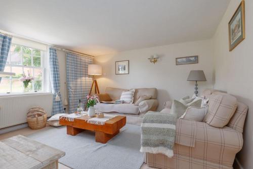 a living room with a couch and a table at Westport Cottage in Wareham