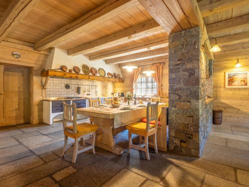 a kitchen with a large wooden table and chairs at Chalet Chalet Anna by Interhome in Grosotto