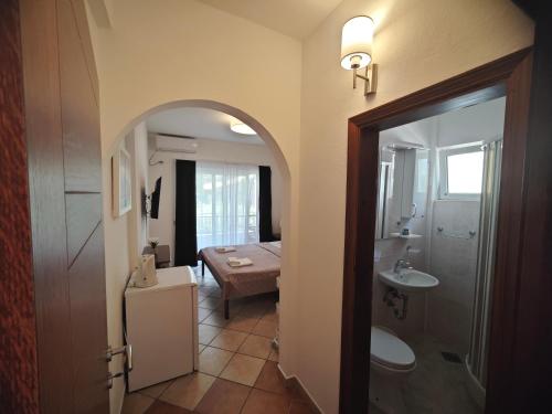 a bathroom with a sink and a toilet and a room at Adriatic Apartment in Ulcinj