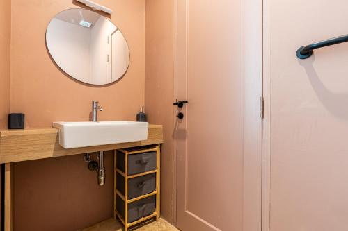 a bathroom with a sink and a mirror at Room in Historic Knights House at the Marina in Senglea