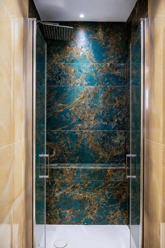 a bathroom with a shower with a blue wall at Donna Teresa Amalficoast in Cetara