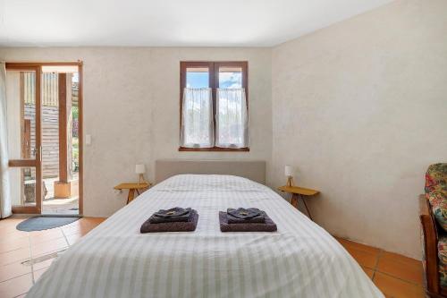 a bedroom with a bed with two towels on it at Studio au Pied de Puycelsi in Puycelci