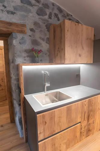 a kitchen with a sink and a counter at Giuly's Home Luxury in Bormio