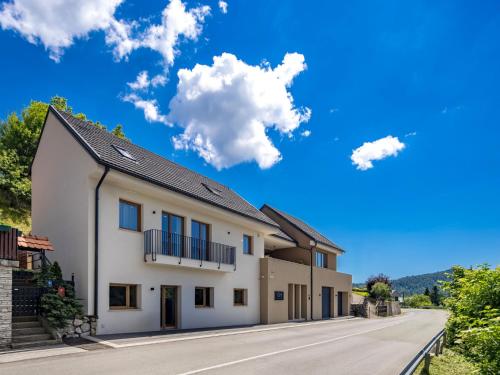 a house on a street with a blue sky at Villa Orso by Interhome in Fužine