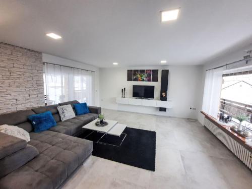 a large living room with a couch and a tv at Apartment Panoramablick Rhön by Interhome in Sandberg