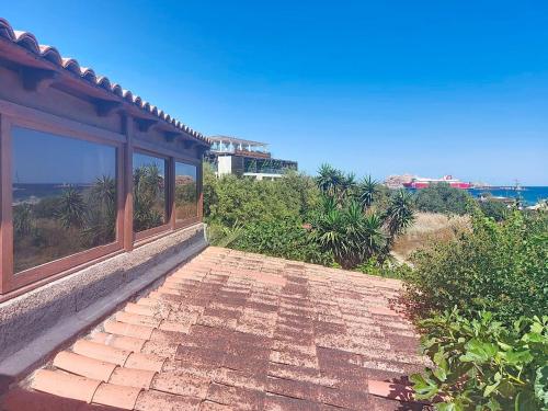 a balcony of a house with a view of the ocean at Holiday Home Posidonie by Interhome in LʼÎle-Rousse