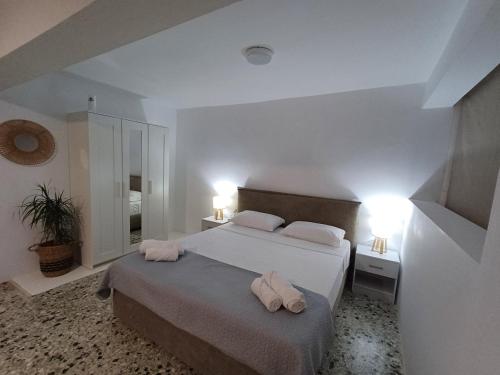 a bedroom with a bed with two towels on it at The Forest Villa in Zacharo