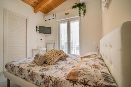 a bedroom with a bed with pillows on it at Oltremura Rooms Agropoli in Agropoli