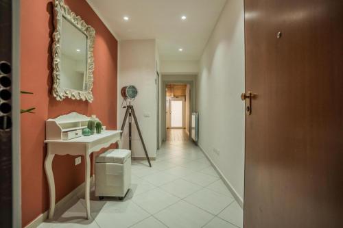 a bathroom with a sink and a mirror on a wall at Oltremura Rooms Agropoli in Agropoli