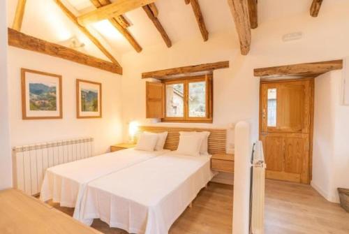 a bedroom with a large white bed in a room at La Cueva Rural Boutique Villa in La Focella