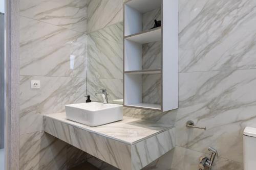 a bathroom with a sink and a mirror at Villa Vibella in Laganas
