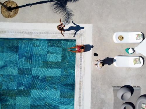 an overhead view of two people swimming in a swimming pool at Althea Resort in Áno Loutrón