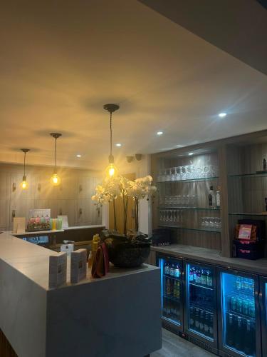 a kitchen with a counter and a bar with machines at Beech Hill Hotel & Spa in Windermere