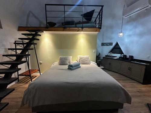 a bedroom with a large bed and a staircase at Domos Blackdomes in Las Trancas
